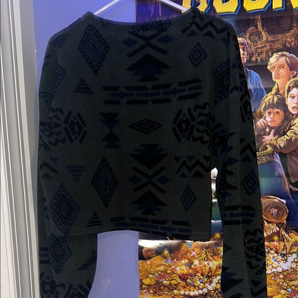 Black Patterned Women's Sweater Crop Top with Dark Green Background.